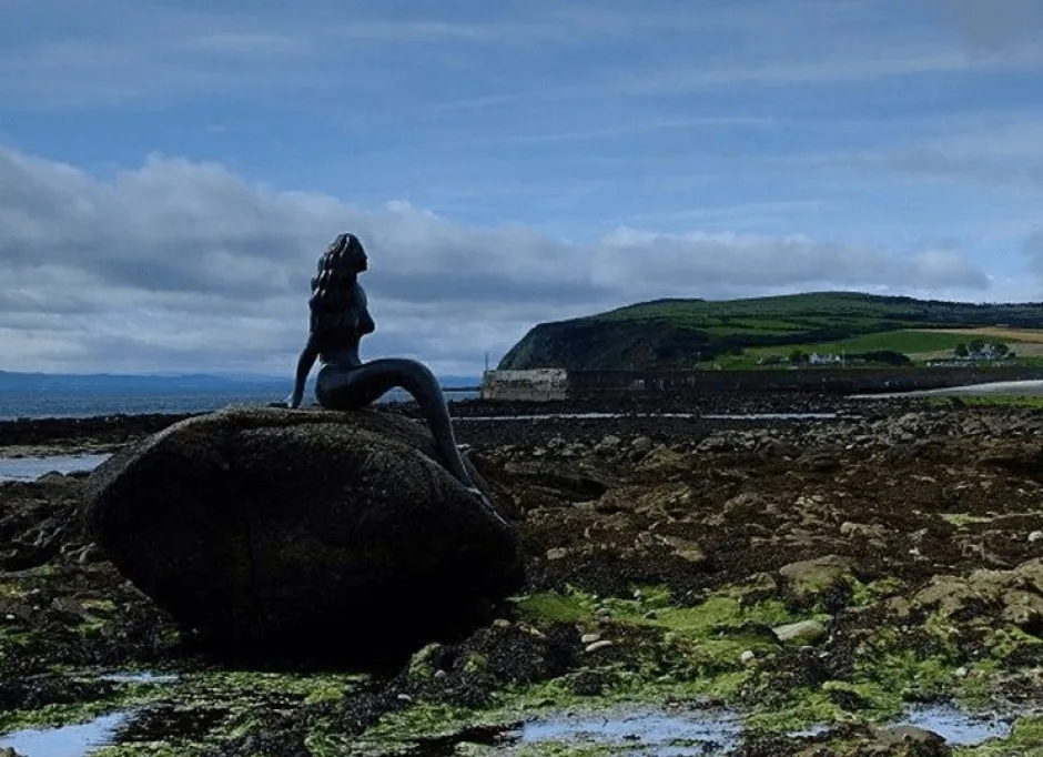 Mermaid sculpture on a rock