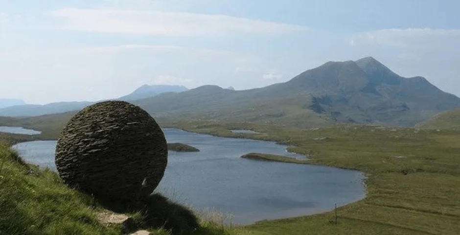 Scottish highland with round sculpture