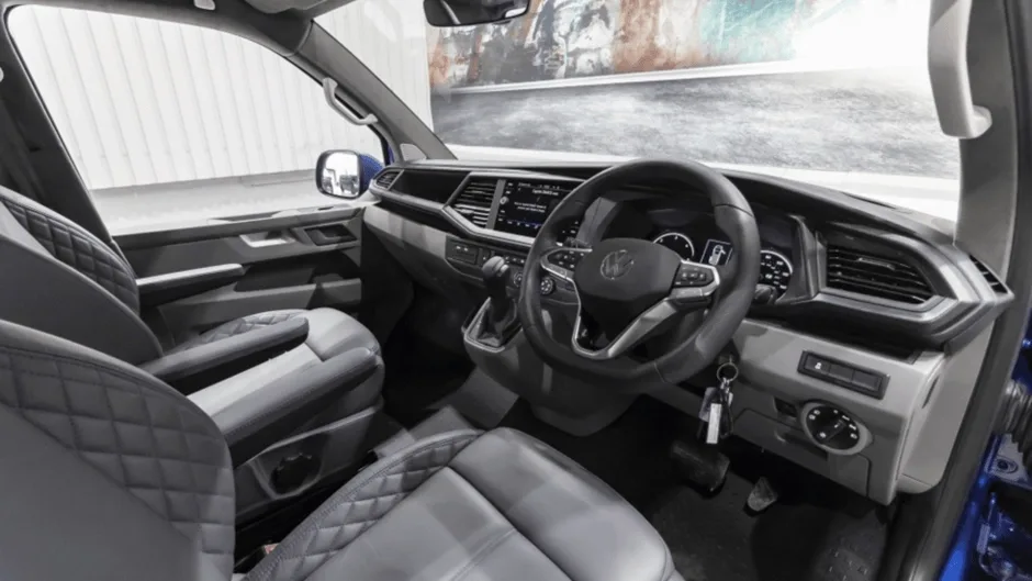 Front of campervan with steering wheel and dashboard