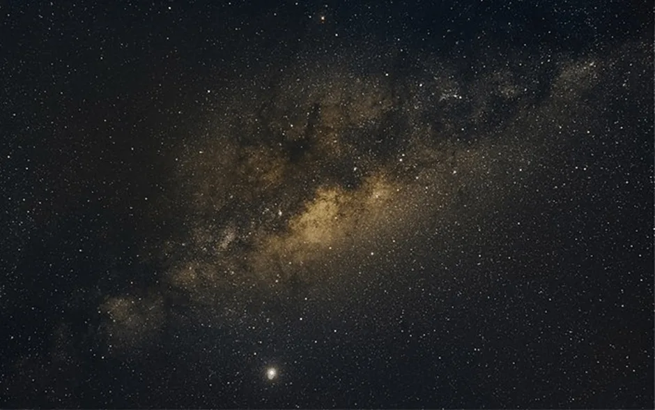 Galaxies in the night sky in golds and black