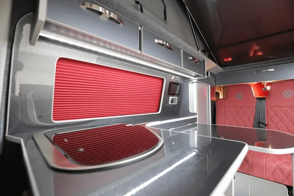Campervan interior with red window shades and seats