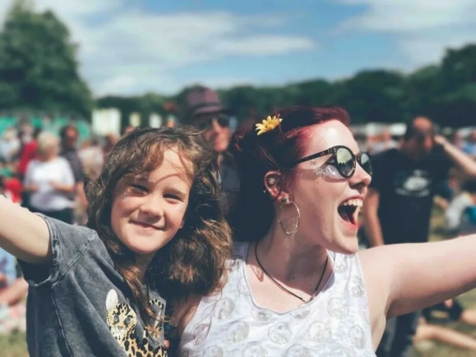 Two people cheering at a campervan friendly festival