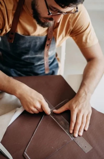 Man measuring fabric with a ruler