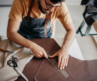 Man measuring fabric with a ruler