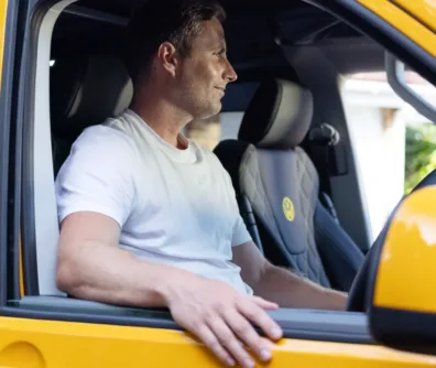 Man sat in a yellow camper van