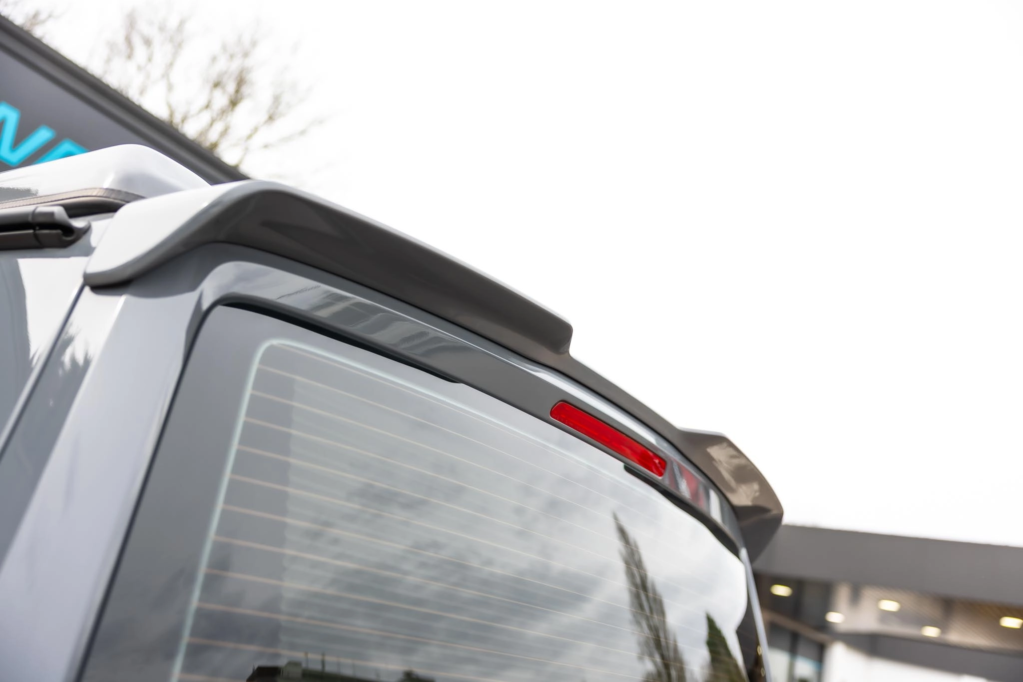 Roof spoiler on the back of a grey campervan