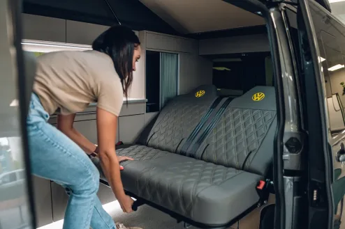 A Lady Folding down a PWA custom stiched Rock & Roll Bed