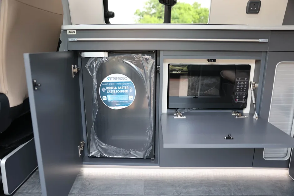 Fridge and microwave inside a campervan