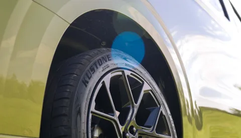 Black wheel on a green campervan