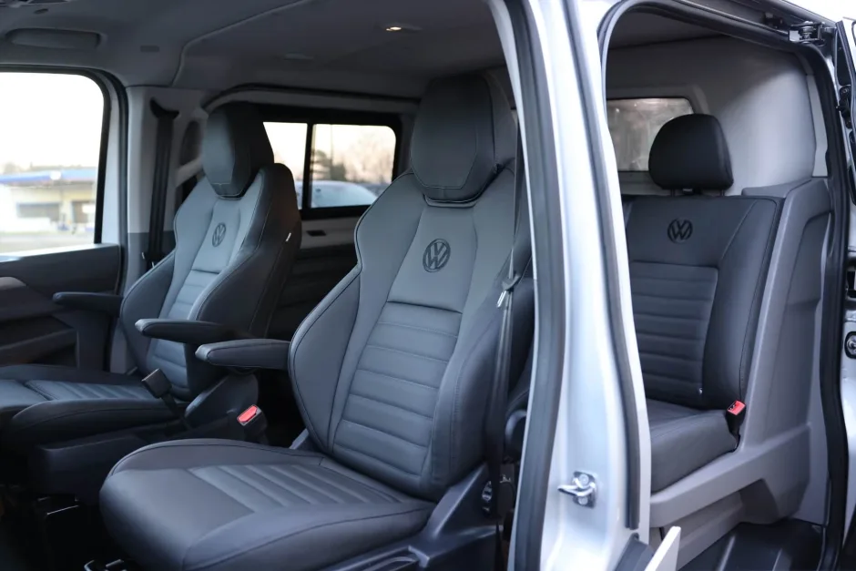 Inside of kombi van with four VW branded seats